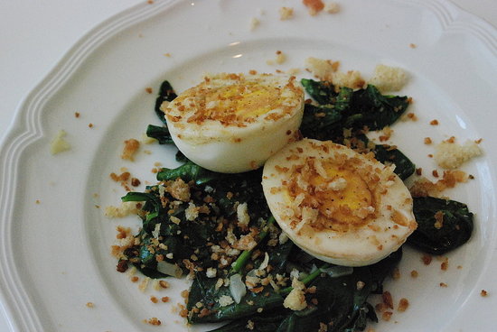 Hard-cooked eggs on a bed of sautéed spinach